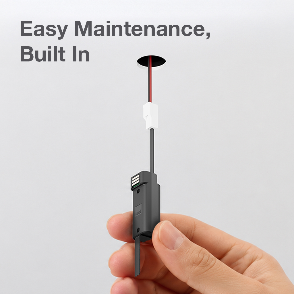 Close-up of a hand holding a DMF Lighting modular LED light engine module designed for quick, below-ceiling replacement and simplified maintenance.